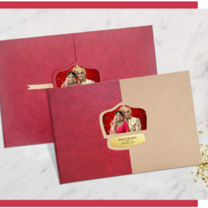 Heritage Majesty royalty wedding album with custom window cover design featuring bride and groom portrait, displayed in elegant red and beige handcrafted finish by Crafted Memories.