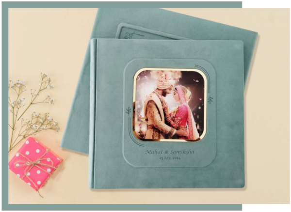 Teal suede layflat wedding photo album with inset cover window featuring a bride and groom portrait and personalized names