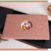 Luxury faux leather photo album with a soft blush cover and decorative picture window, featuring a personalized wedding photo centerpiece