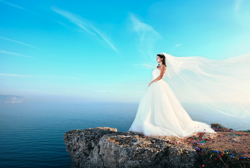 A high-quality heirloom wedding photo of a bride on a cliffside, representing the premium large-scale albums (12 to 18 inches wide) created by Crafted Memories.