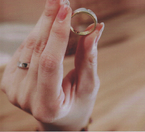 Bride holding wedding ring — preserve your wedding memories in a custom layflat photo album by Crafted Memories